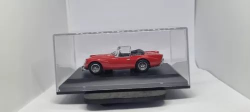 1/43 scale red diecast model car in clear display case, black base