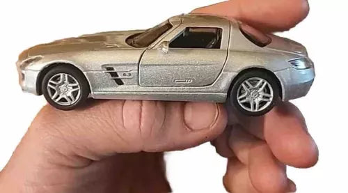 Silver 1:36 diecast toy car with AMG-style body, held in hand, front 3/4 view
