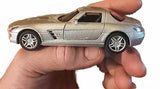 Silver 1:36 diecast toy car with AMG-style body, held in hand, front 3/4 view