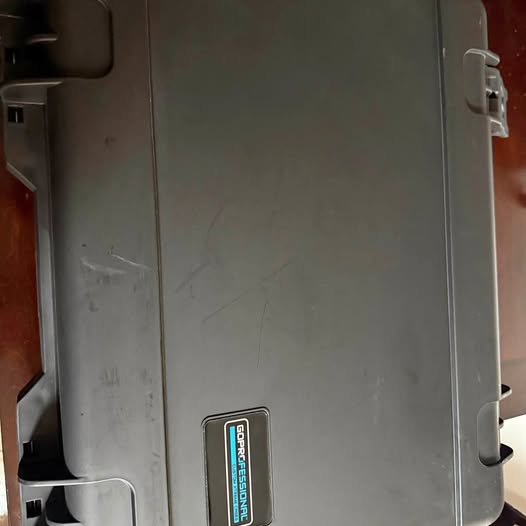 Gray plastic drone body with side port and warning label