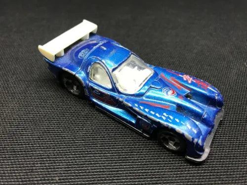Blue 1:64 diecast race car with white roof and racing decals