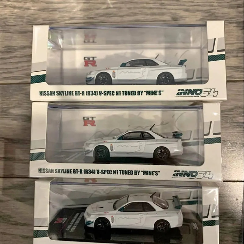 1:64 Nissan Skyline GT-R diecast model in retail box, white with dark wheels