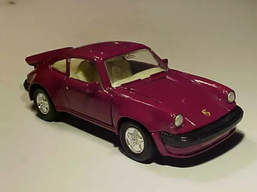 Maroon diecast toy sports car with black front bumper and gold Porsche emblem