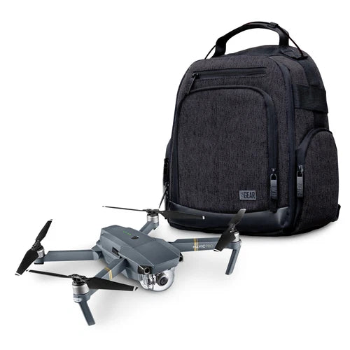 Black drone backpack travel bag with front zip pocket and padded handle, shown with drone