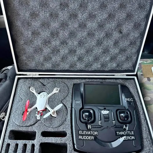 White mini quadcopter drone with black transmitter controller and LCD screen