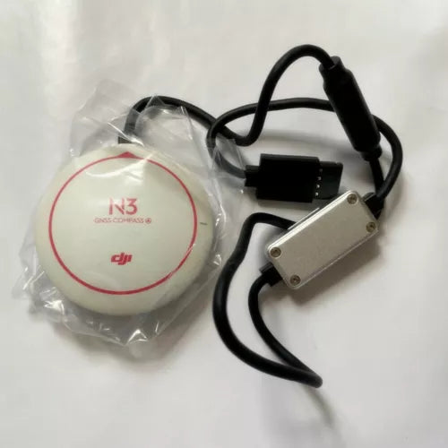 DJI N3 GPS module with white circular puck and cable, black plug, metal mounting bracket