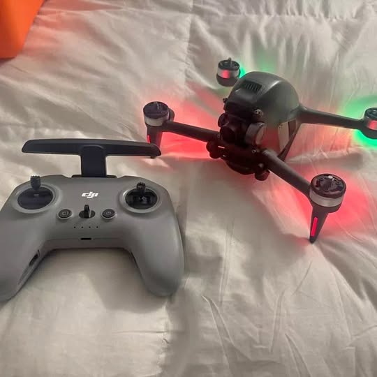 FPV camera drone with propellers and motion controller, gray