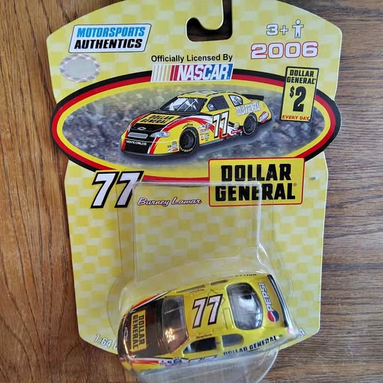 Yellow, black, and red diecast race car in retail blister pack, #77