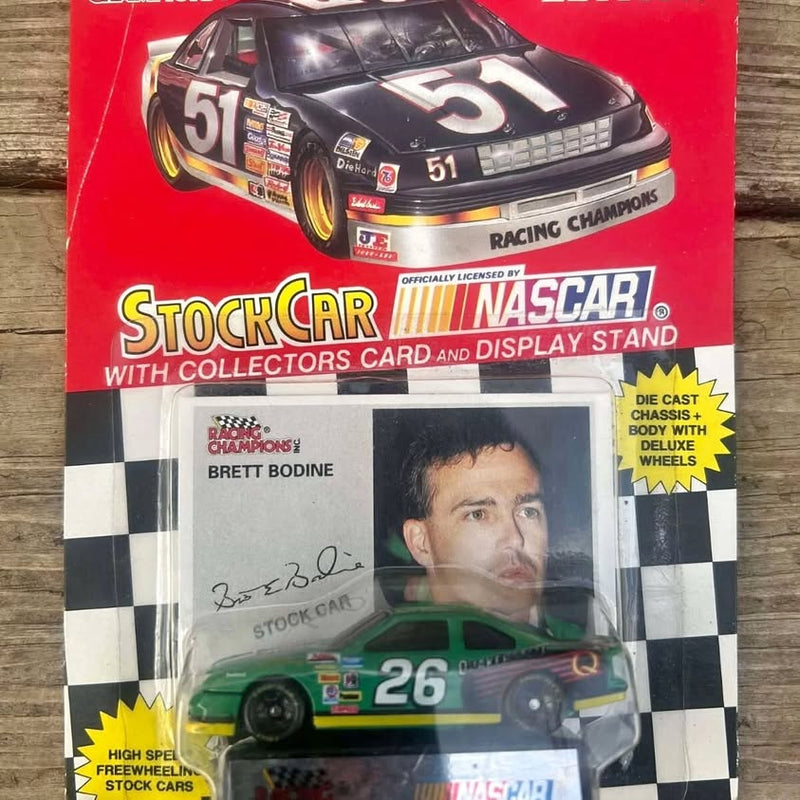 1:64 scale diecast race car, green #26 Quaker State Ford in display packaging
