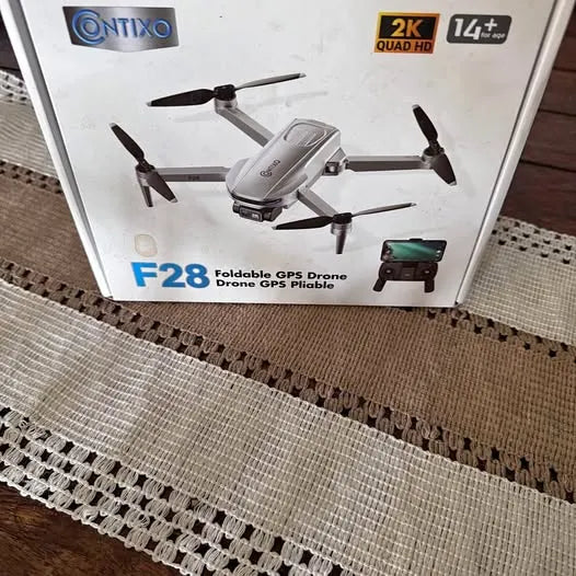 Foldable GPS drone packaging with quadcopter image, 2K Quad HD and 14+ min