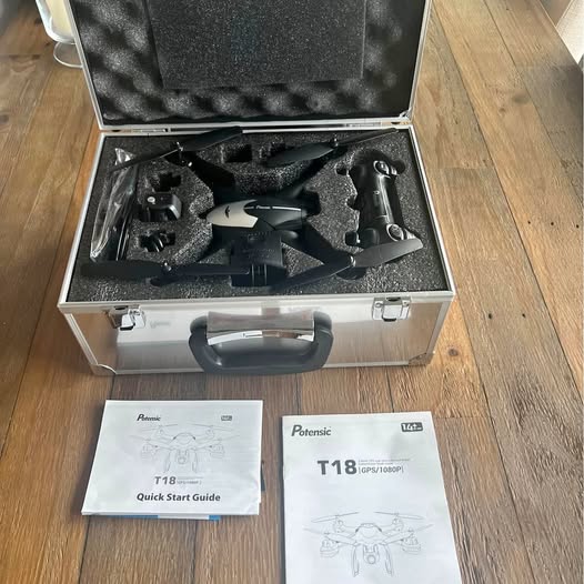 Black drone in open hard case with Quick Start Guide manuals