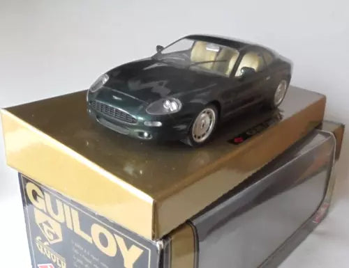 Diecast Aston Martin DB7 model car, dark metallic color, on retail display box