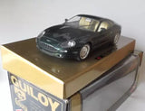 Diecast Aston Martin DB7 model car, dark metallic color, on retail display box