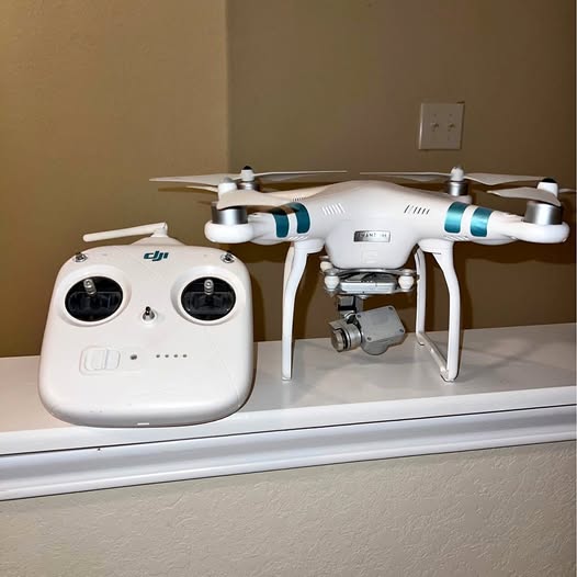 DJI Phantom quadcopter drone with white body and four propellers