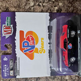 Red diecast race car in clear blister packaging on purple box