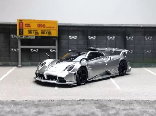 Silver racing diecast model car with front splitter and wide tires