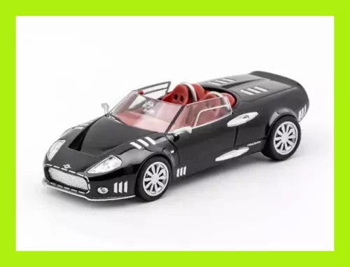 Black diecast sports car model with red interior, front three-quarter view