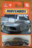 Gray Matchbox diecast supercar in clear blister package, front three-quarter view