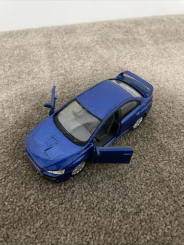 Blue die-cast model car with open door, 1/36 scale.