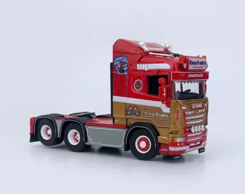 Red diecast Scania tractor unit truck model, front 3/4 view