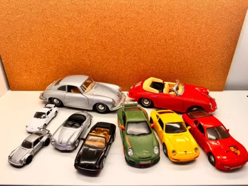 Assorted diecast toy car models in silver, green, yellow, and red