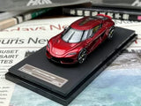 Red diecast sports car model on black display base, 1/64 scale