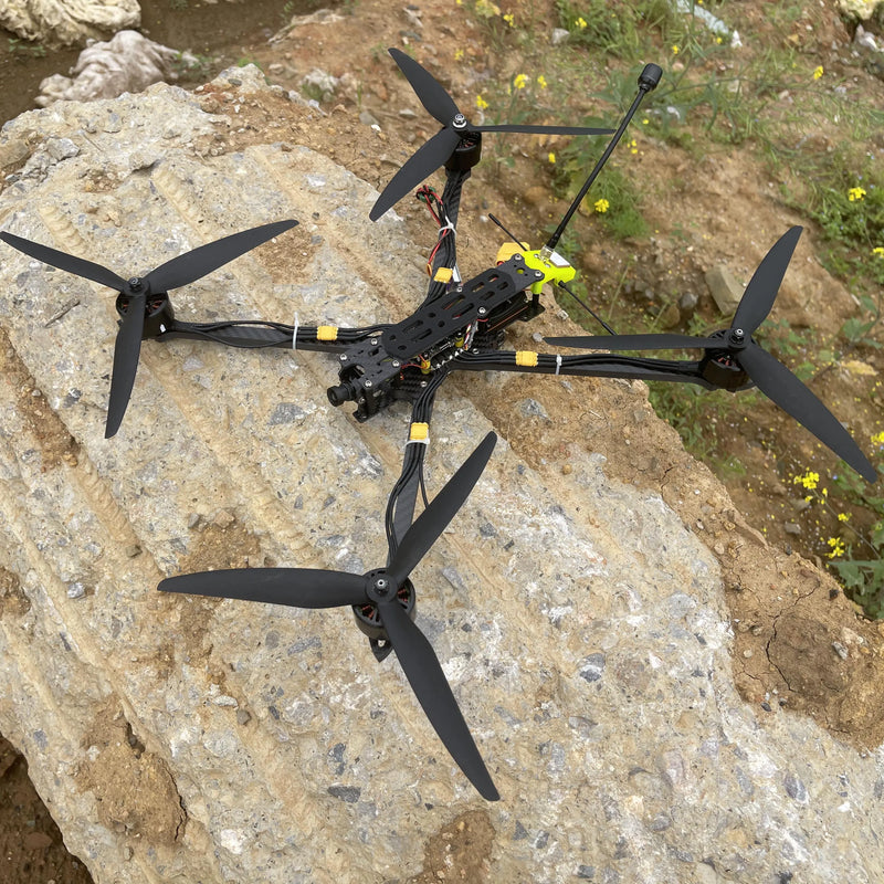 Black mini FPV quadcopter drone with four propellers and carbon-fiber frame