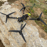 Black mini FPV quadcopter drone with four propellers and carbon-fiber frame