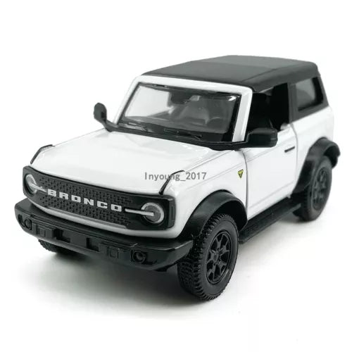 White Ford Bronco diecast model car with black roof and front grille