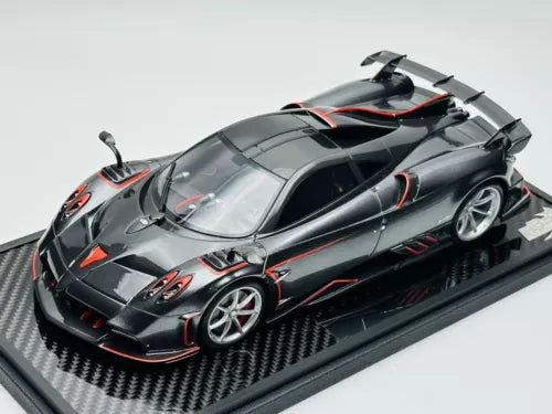Met carbon black diecast model car with red racing accents, on display base