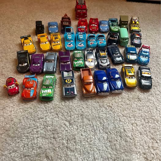 Assorted diecast toy car vehicles, various colorful designs and sizes