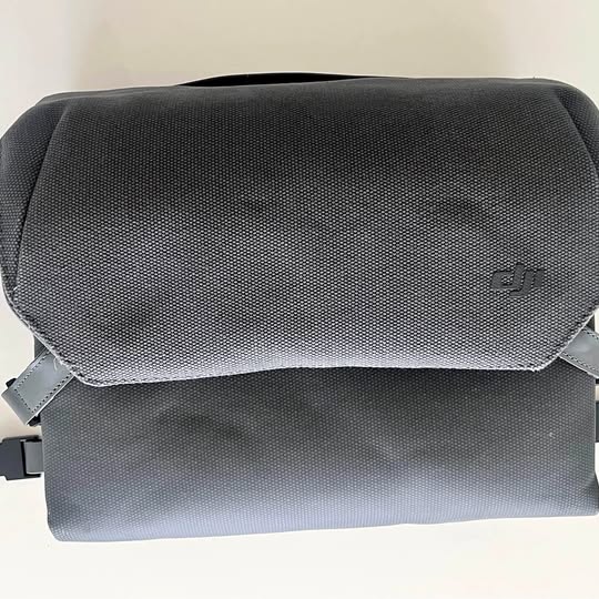 DJI drone bag with textured fabric, fold-over flap, and small gray logo