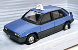 Corgi diecast scale model taxi car, light blue with black trim, front-left view.