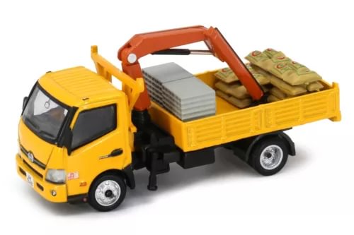 Diecast yellow crane truck with flatbed and green cargo load