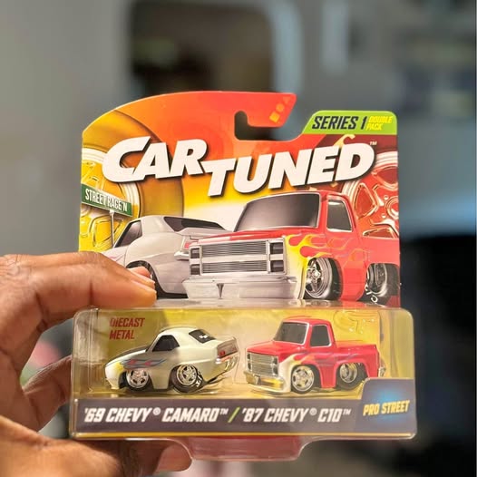 Diecast metal toy cars in retail box, red and white vehicles with chrome wheels