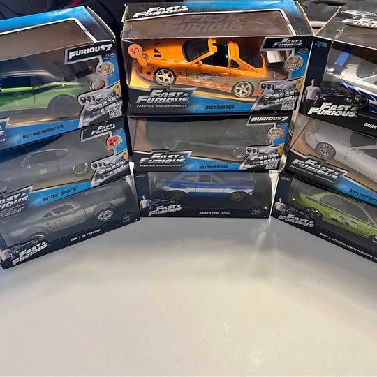 Diecast collector car in box, orange sports car model with detailed packaging
