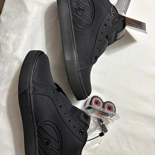 Black Heelys skate shoes with built-in wheel near the toe