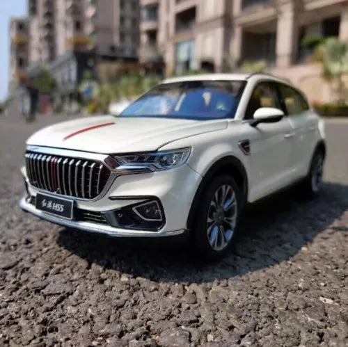 Diecast model car, white, front 3/4 view with grille and headlights