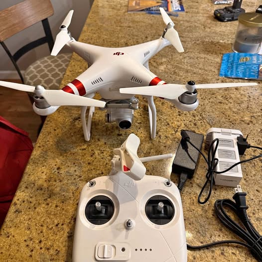 White DJI Phantom 3 Standard drone with four propellers and front camera