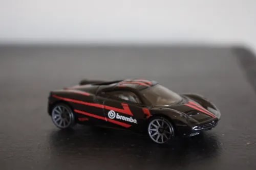 Pagani Huayra 1:64 diecast model car, black with red racing stripes, loose