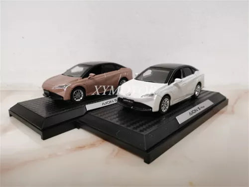 1/43 AION S Plus diecast model cars, white and brown, on black display bases