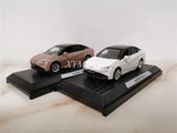 1/43 AION S Plus diecast model cars, white and brown, on black display bases