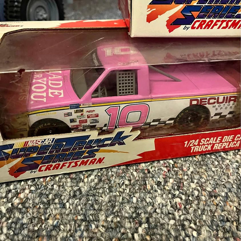 1/24 diecast NASCAR truck replica, pink cab and white body with red number 10, in box
