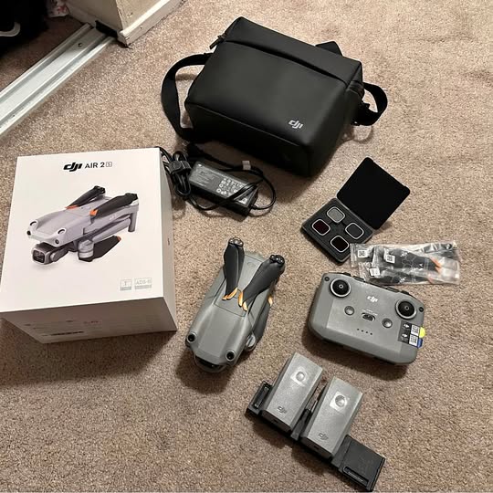 Drone travel bundle with gray DJI drone, remote, batteries, and black carrying bag
