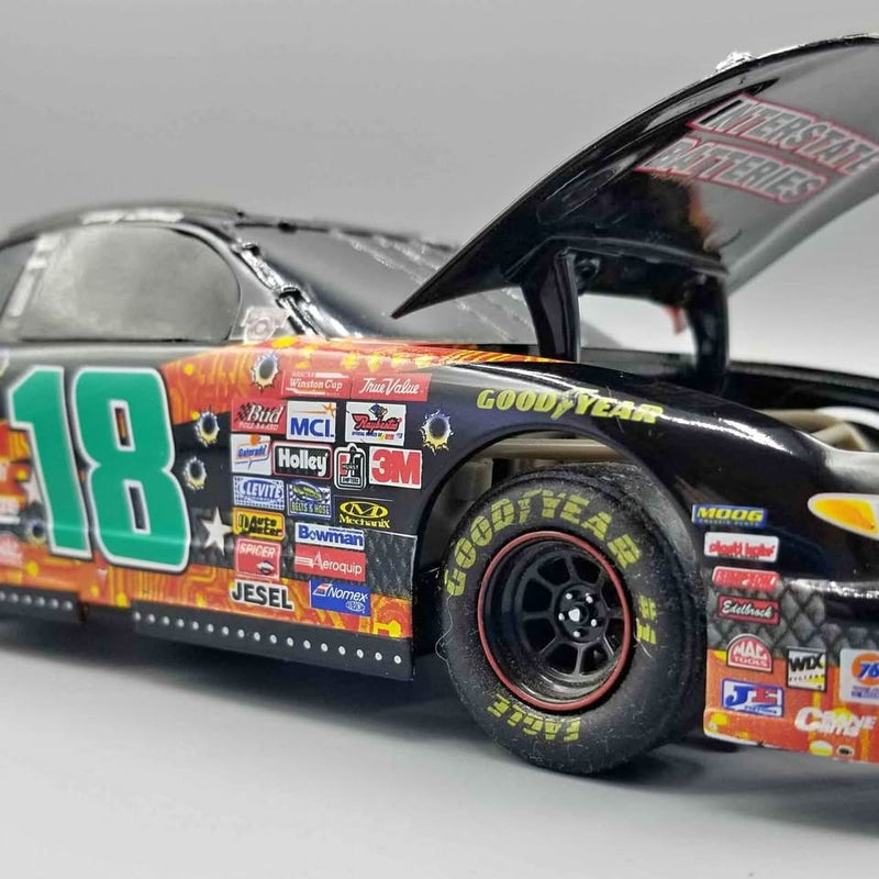 Die-cast NASCAR race car with No. 18, dark blue body, Goodyear tires, open hood