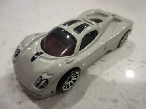 Gray diecast toy race car, Hot Wheels style, 1:64 scale, front three-quarter view