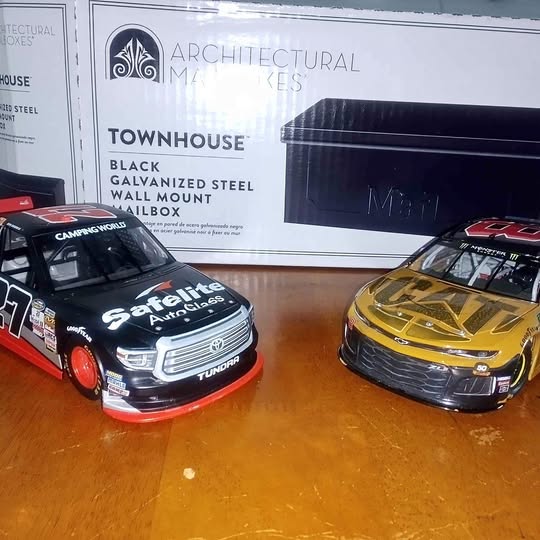 1/24 scale NASCAR diecast race cars, black/red and yellow/black, front three-quarter view