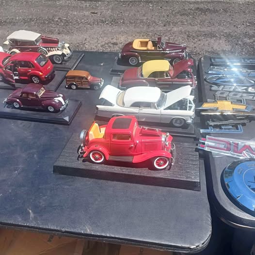 Diecast toy cars set with red, maroon, and yellow cars on a display tray