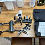 Folding camera drone kit with remote and spare propellers in case