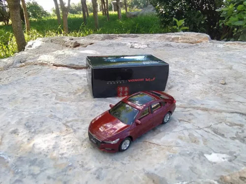 Red 1:64 diecast model car with display box